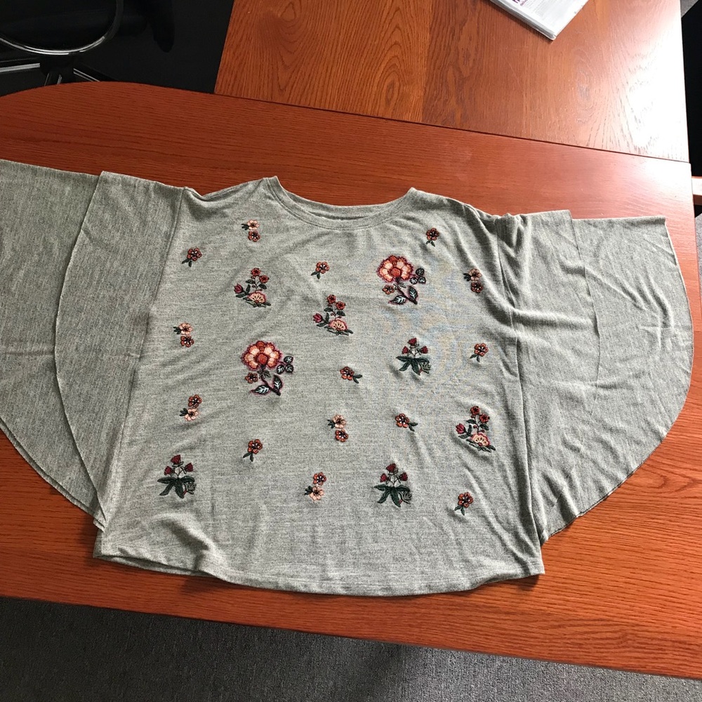 Grey poncho style top with pretty embroidery.